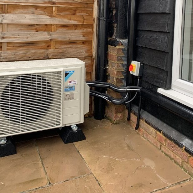 Daikin air conditioning outdoor unit installed on a patio by EcoGas